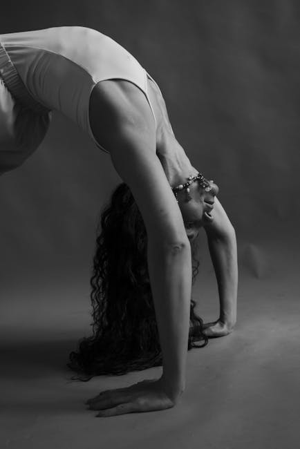 Woman in a graceful yoga pose focusing on deep stretching.